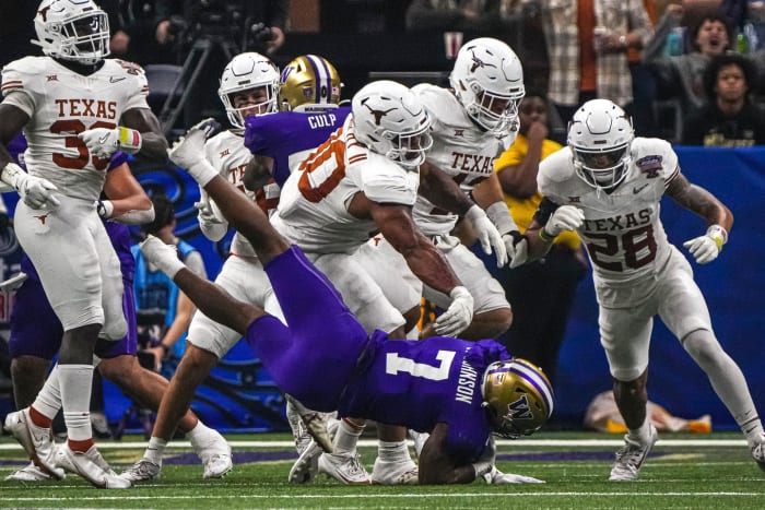 Texas Longhorns defensive lineman Byron Murphy II (90) throws Washington running back Dillon Johnson (7) to the ground during the Sugar Bowl College Football Playoff semifinals. © Aaron E. Martinez/American-Statesman / USA TODAY NETWORK